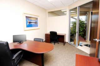 office with carpet and boat picture on the wall