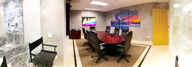 panoramic view of conference room with big table, chairs, and flat screen tv