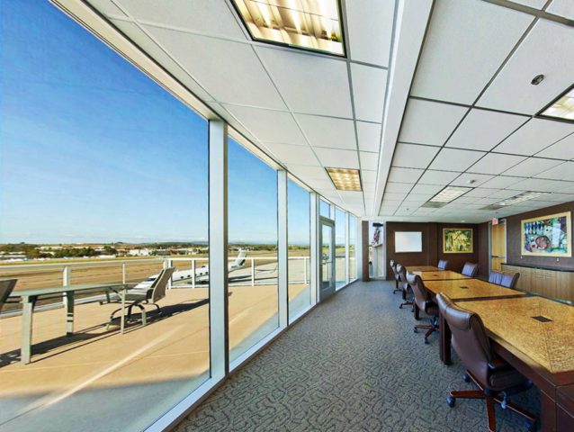 Executive conference room with large windows that overlook the Palomar Airport runway in Carlsbad, CA