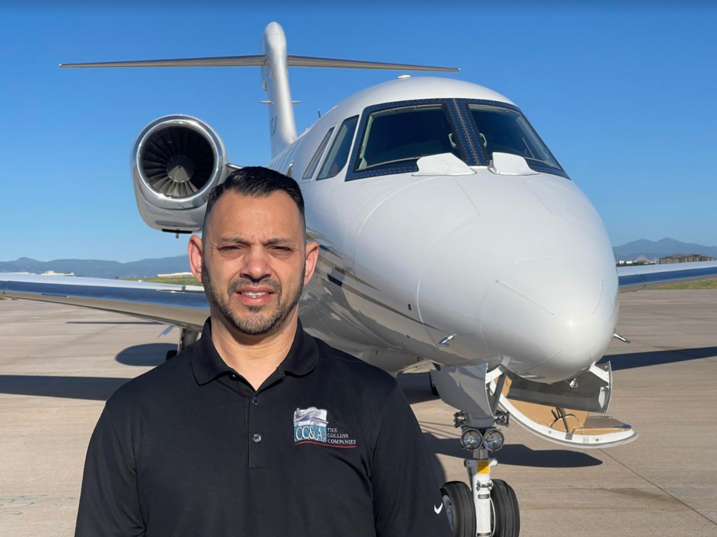 Man in front of a private jet on a runway